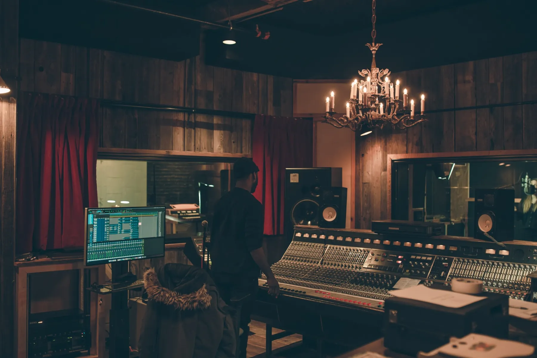 Sound: an engineer at a mixing desk in a recording studio